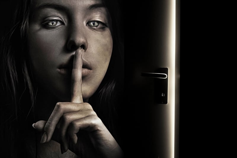 Silhouette of a person whispering a secret